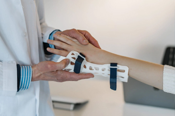 Doctor fitting a patient's arm with a custom 3D-printed medical brace, showcasing advanced healthcare applications of 3D printing technology
