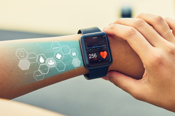 Person using a smartwatch to monitor heart rate and health data, representing wearable health technology and real-time fitness tracking