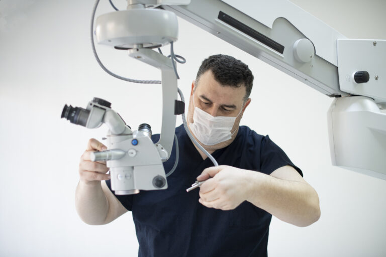 Image of technician servicing an operating microscope. Continued maintenance helps equipment maintain value and is attractive to lenders.